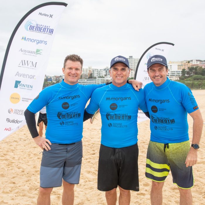 Wipeout dementia participants and ambassadors pose on beach for photo