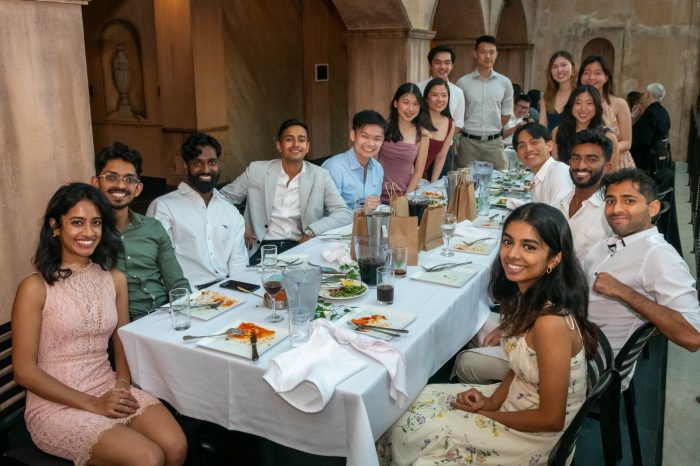 SWS Clinical Medicine Graduates having dinner at a restaurant and smiling at their table