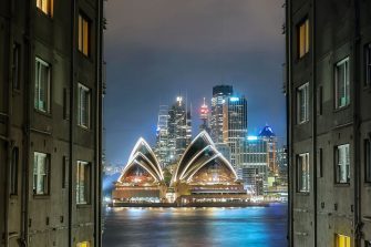 Photo of the city of Sydney featuring the Opera House at night