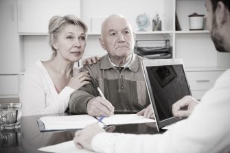 Elderly couple consulting with doctor