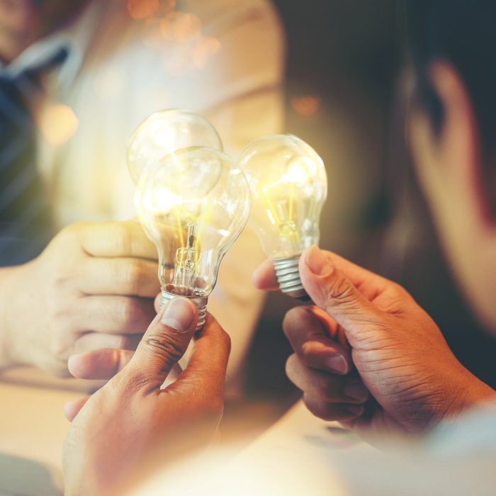 Sharing idea for help concept, Colleagues sharing a light bulb of idea