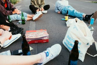 Group of young people drinking and smoking in the street
