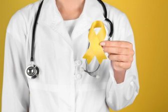 Doctor holding yellow ribbon