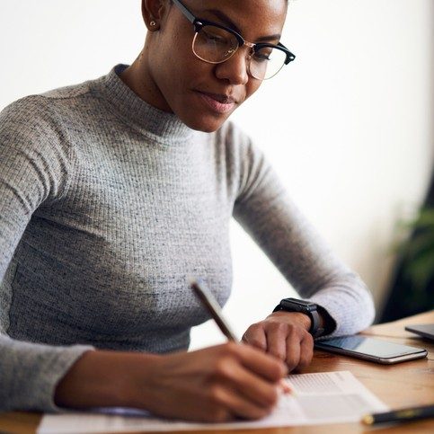 female writing paper