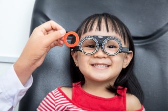 Asian Little Girl Doing Eyes Examination at An Optical Shop