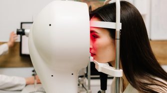 Corneal topography eye test with red light for eye health, correction, and treatment. Doctor examines cornea using advanced imaging to detect vision issues like astigmatism or keratoconus