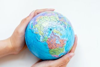 Hands holding a globe