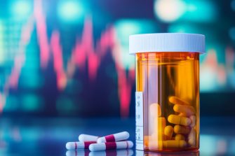 Close-up of a prescription bottle next to a growing stock market chart, pharmaceutical business success.