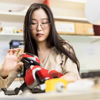 Computer Science Student working with Robot in Lab