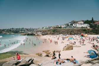 sumptuous summer beach scene featuring a busy tamarama beach and clear blue water