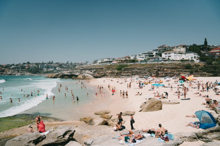 sumptuous summer beach scene featuring a busy tamarama beach and clear blue water