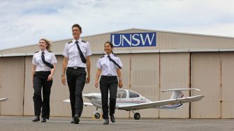 Image of three UNSW Aviation students doing the top gun reenactment