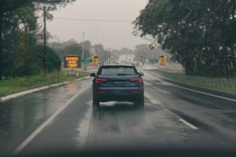 Black car on a wet road during daytime