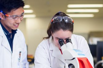 Science students working with a microscope