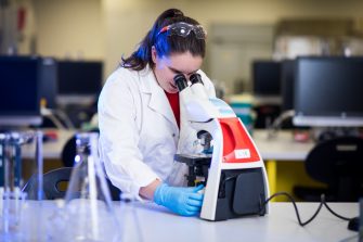 Photograph of students using microscope