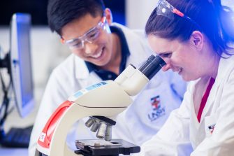 Photograph of students using microscope