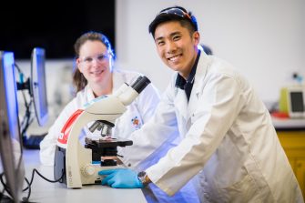 Photograph of students using microscope