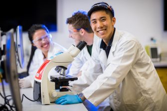 Photograph of students using microscope