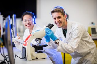 Photograph of students using microscope