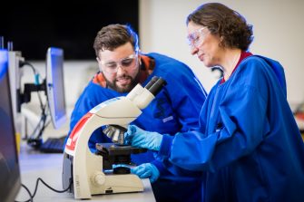 Photograph of students using microscope