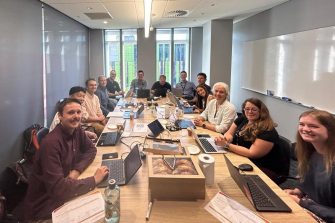 Groupof meeting attendees sitting at a boardroom table