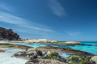 Rocky shoreline under a blue sky