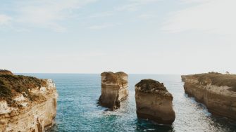 Pillars of rock formations sticking out of ocean