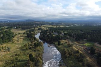 River in Fyshwyck viewed from air surrounded by green fields
