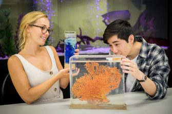 Photograph of science students exaining water organisims and structures