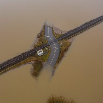 Flooded road passing through the railway. A road under water