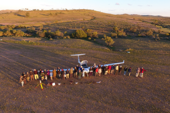 group photo of staff around plane
