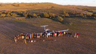 group photo of staff around plane