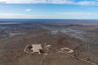 A high aerial photo of a newly built up road and adjoining areas on an enormous floodplain covered in channels