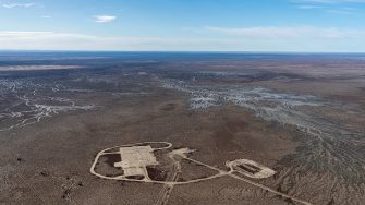 A high aerial photo of a newly built up road and adjoining areas on an enormous floodplain covered in channels