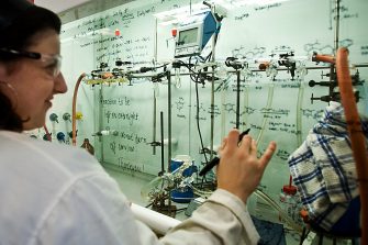 Scientist writing on fumehood