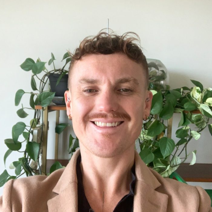 A person standing in front of potted plants