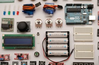 Batteries and assorted circuit board parts lying on a table