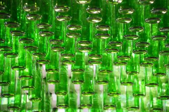 Multiple upside-down green bottles
