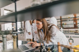 Woman working on a laptop in a laboratory