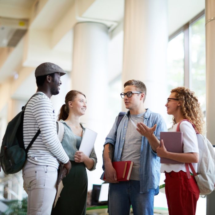 Group of casual groupmates discussing their thoughts about working over home task for next lesson