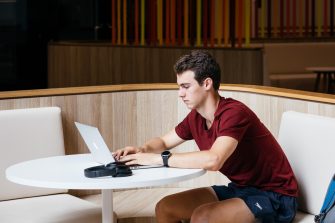 Student sitting at table on laptop