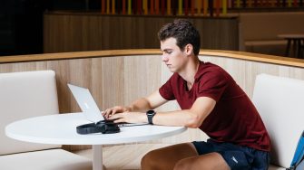 Student sitting at table on laptop