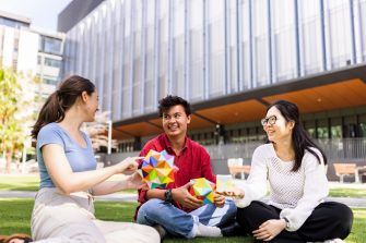 A group of UNSW students sitting on the Alumni Lawn