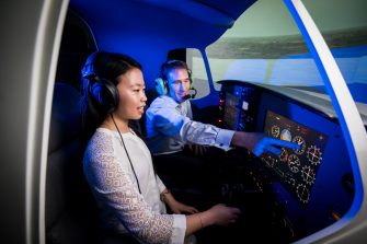 A student and educator in the UNSW flight simulator