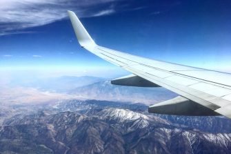 Aeroplane wing over mountains
