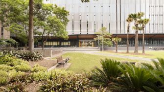 Exterior photo of the D26 building with garden beds in foreground