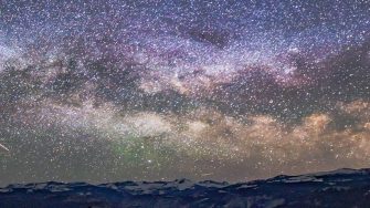 Milky way at night above rocky landscape