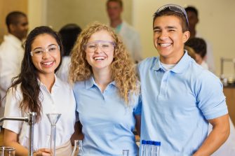 Three smiling school kids