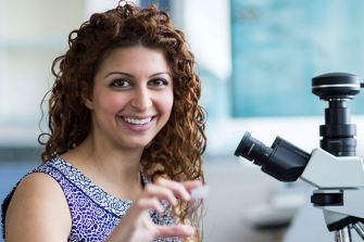 Smiling woman at miscroscope