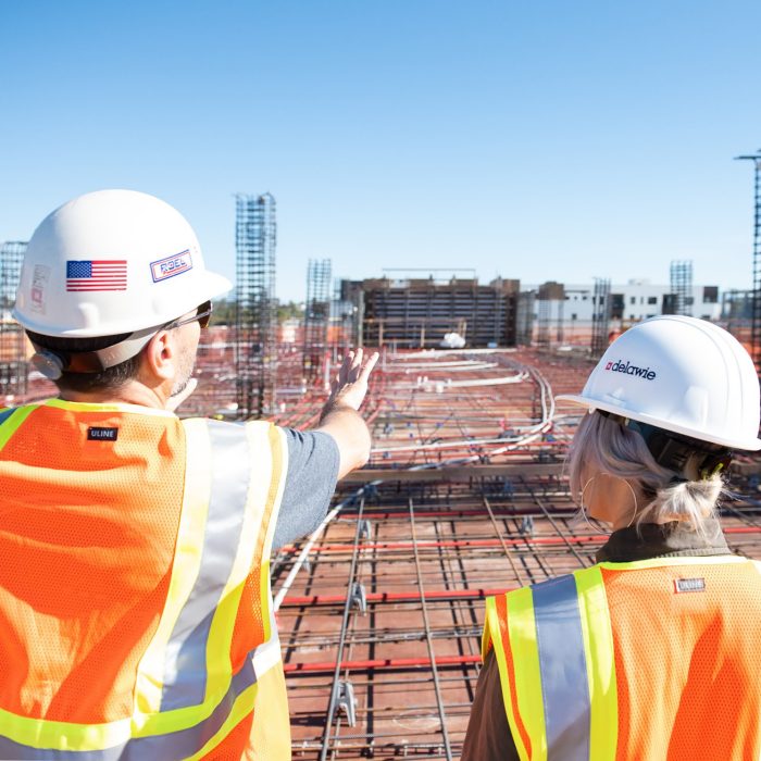 2 workers with hard hats on building site